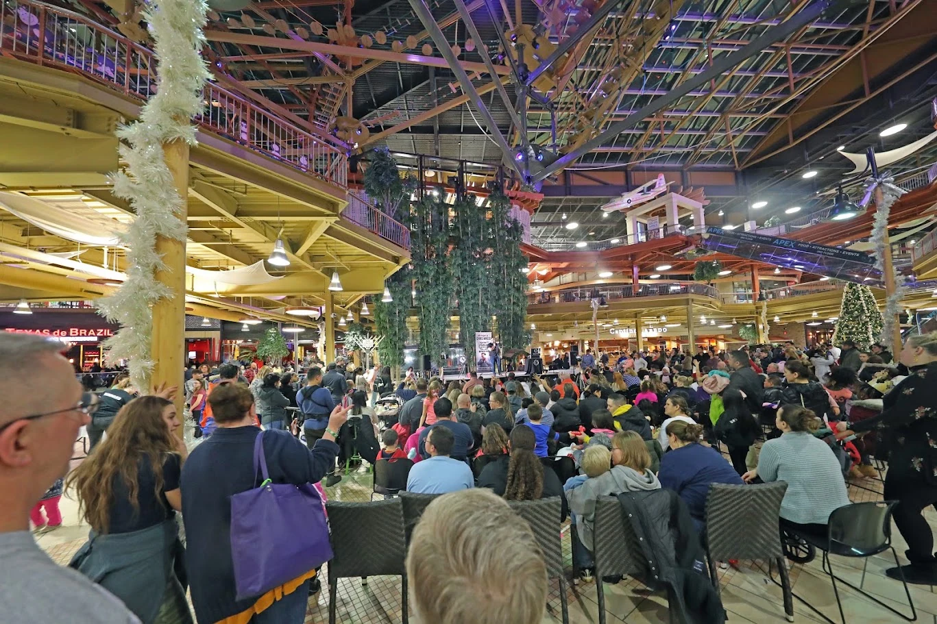 A large audience gathered in a multilevel venue for a Chris Wheel magic show