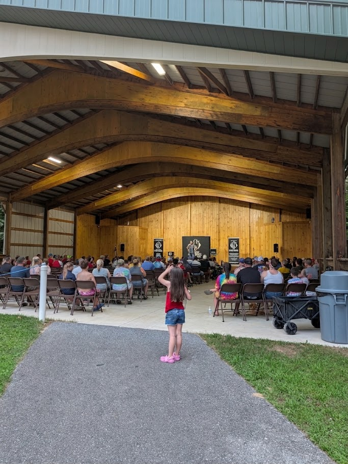 Chris Wheel performing on stage for families inside the Moose Hillock pavilion